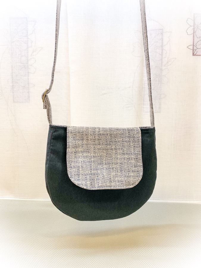 Bandolera artesanal negra con solapa de tweed gris, bolso hecho a mano en Can Baró, Barcelona